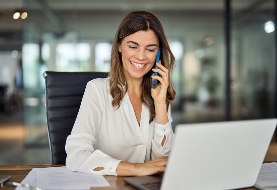 Woman smiling while one the phone