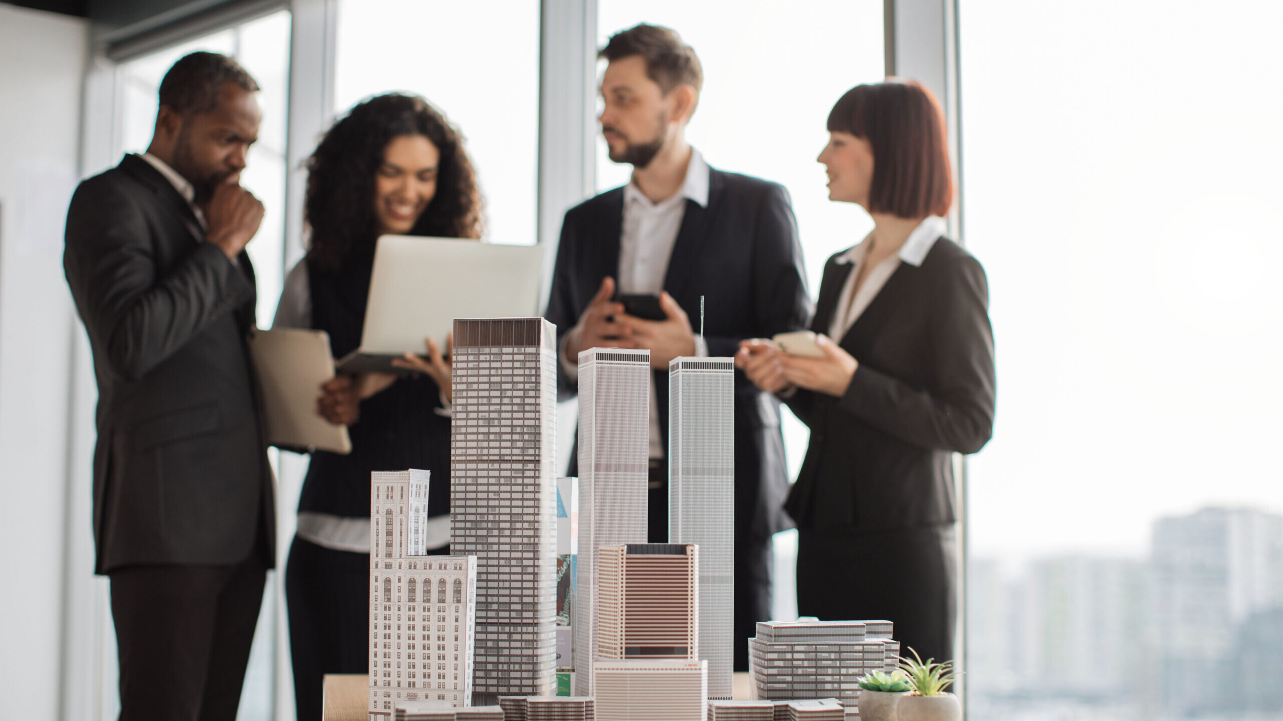 Group of investors reviewing a real estate development model for a Self-Directed IRA syndication
