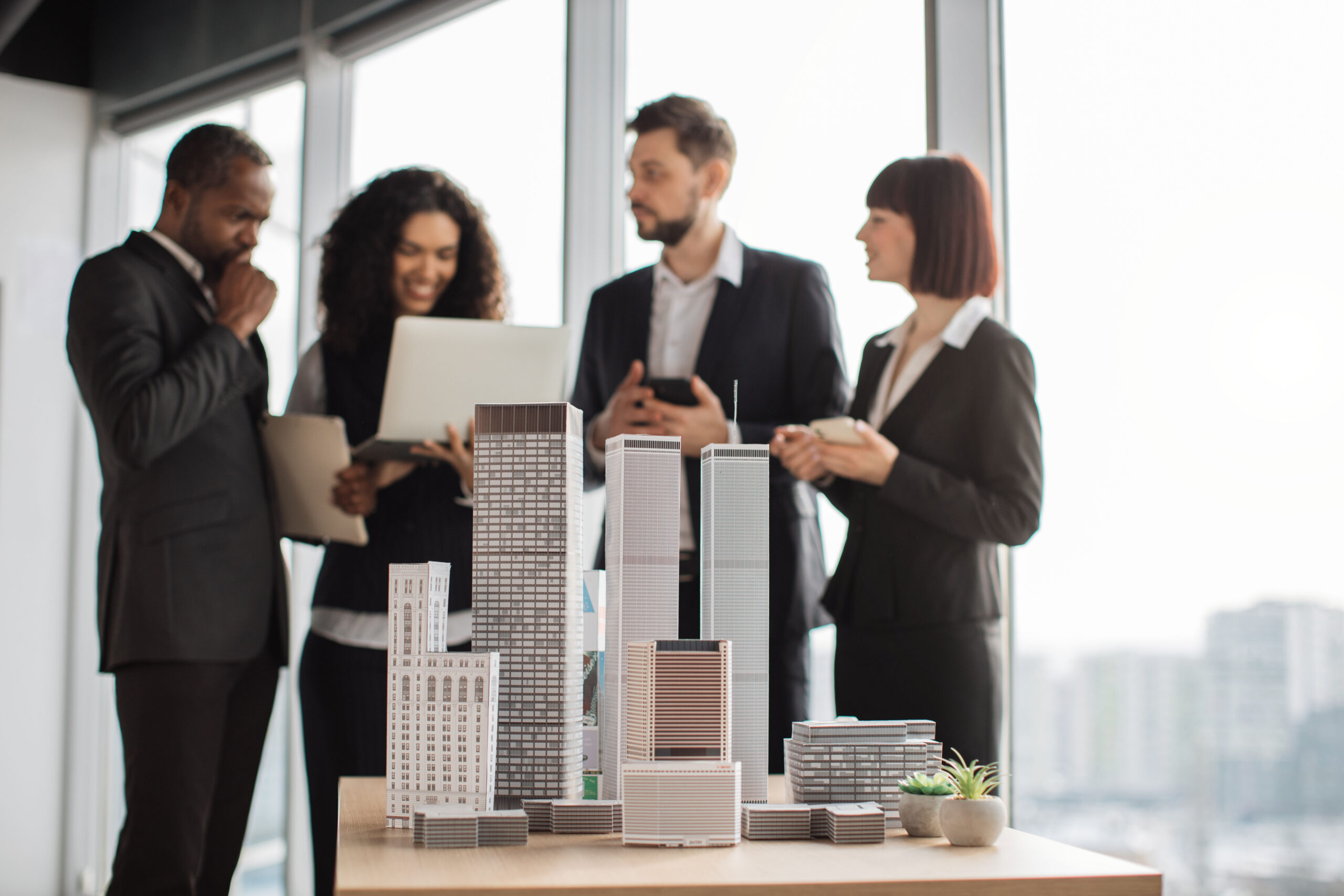 Group of investors reviewing a real estate development model for a Self-Directed IRA syndication
