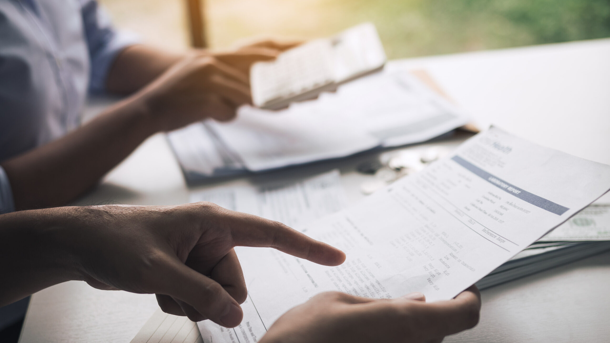 Financial advisor and client reviewing 401(k) rollover paperwork before moving funds into a Self-Directed IRA