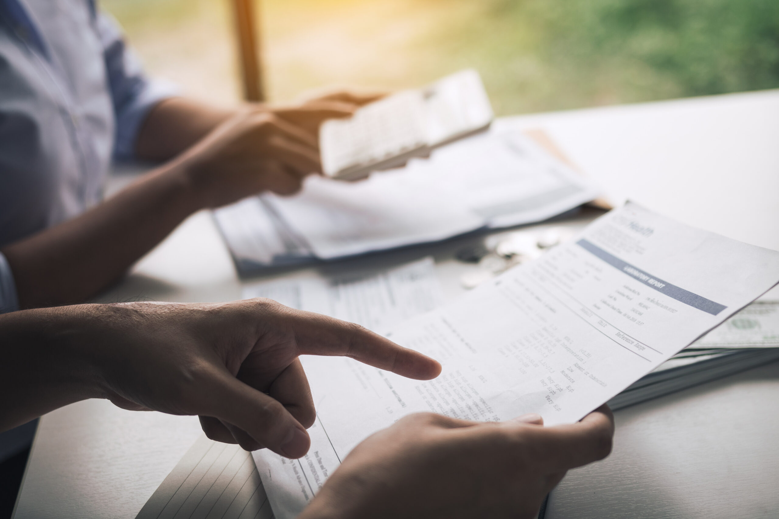 Financial advisor and client reviewing 401(k) rollover paperwork before moving funds into a Self-Directed IRA