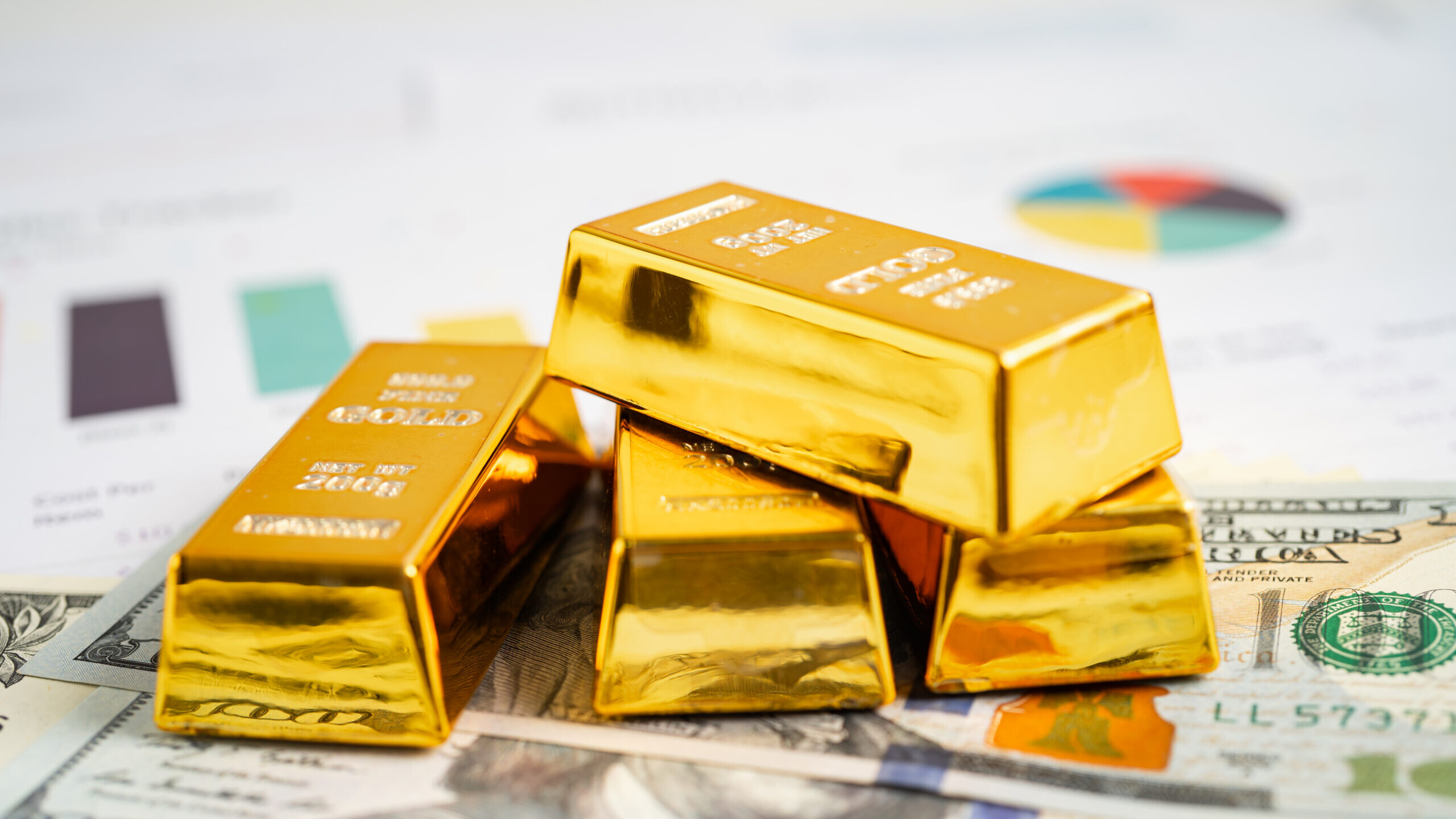 Gold bars on $100 bills representing a Gold IRA rollover