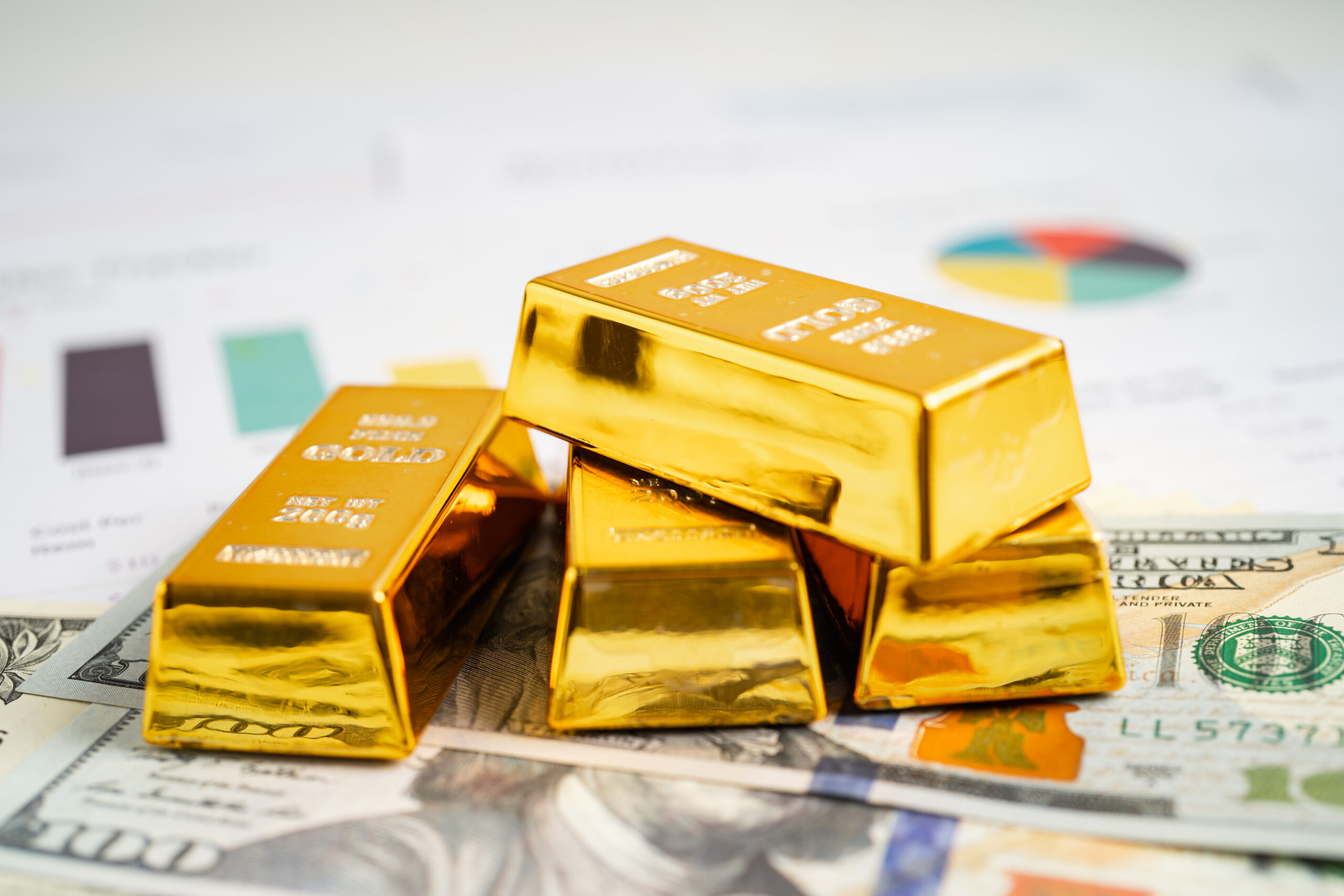 Gold bars on $100 bills representing a Gold IRA rollover