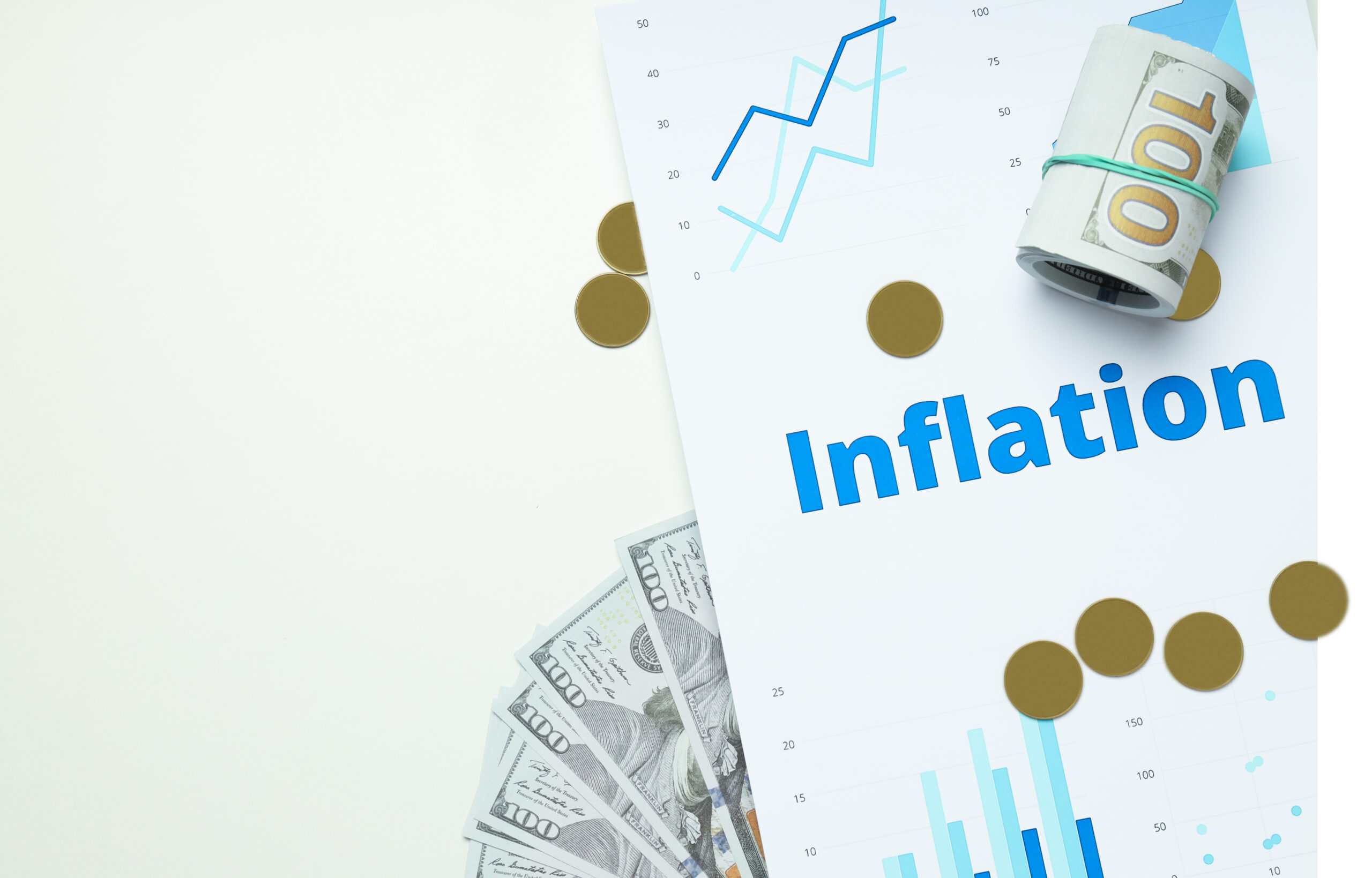 Rolled and fanned hundred-dollar bills, gold coins, and a rising financial chart labeled Inflation, symbolizing the impact of inflation on investment returns.