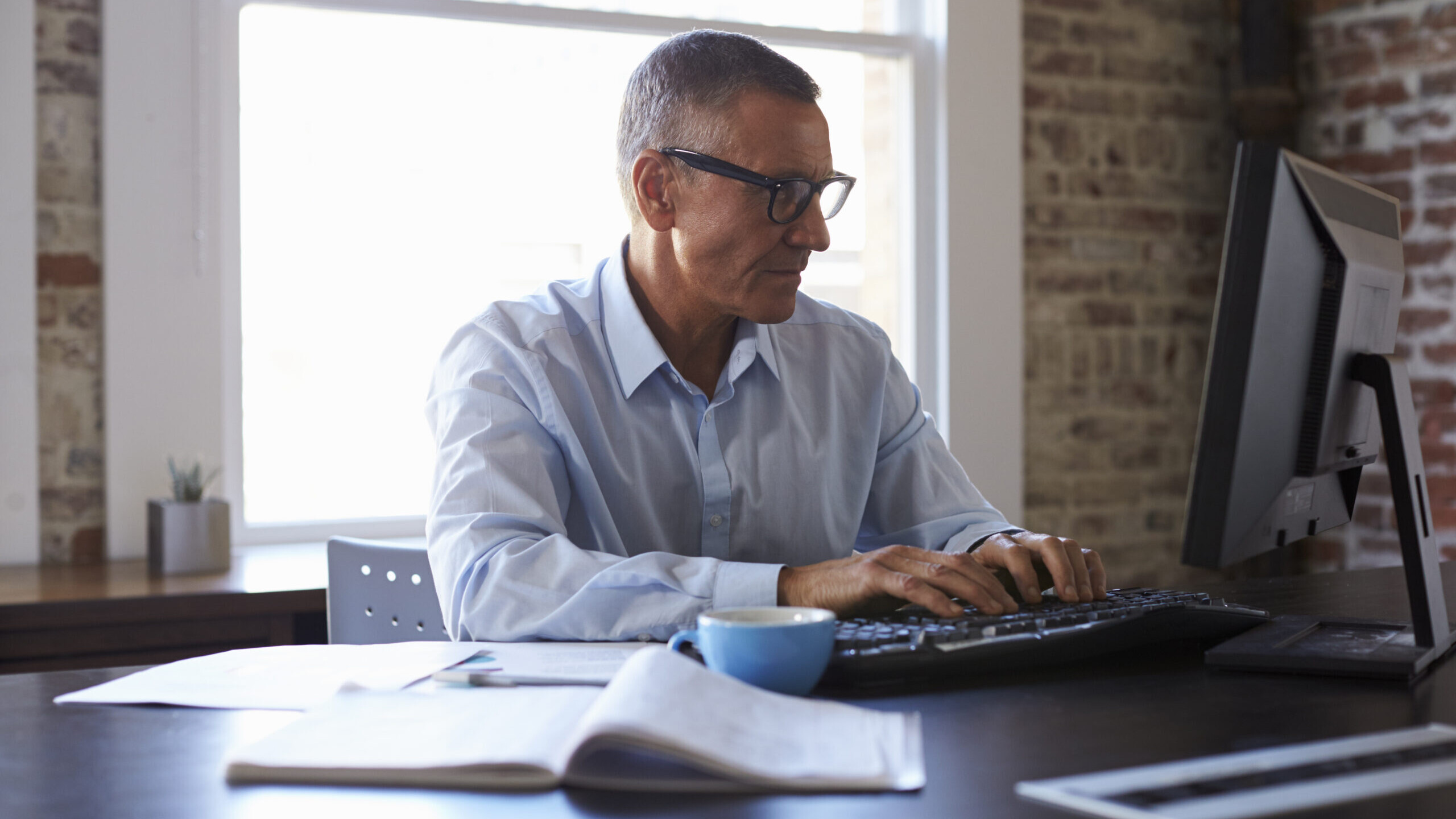 Self-employed professional managing his Self-Directed 401(k) investments from his office