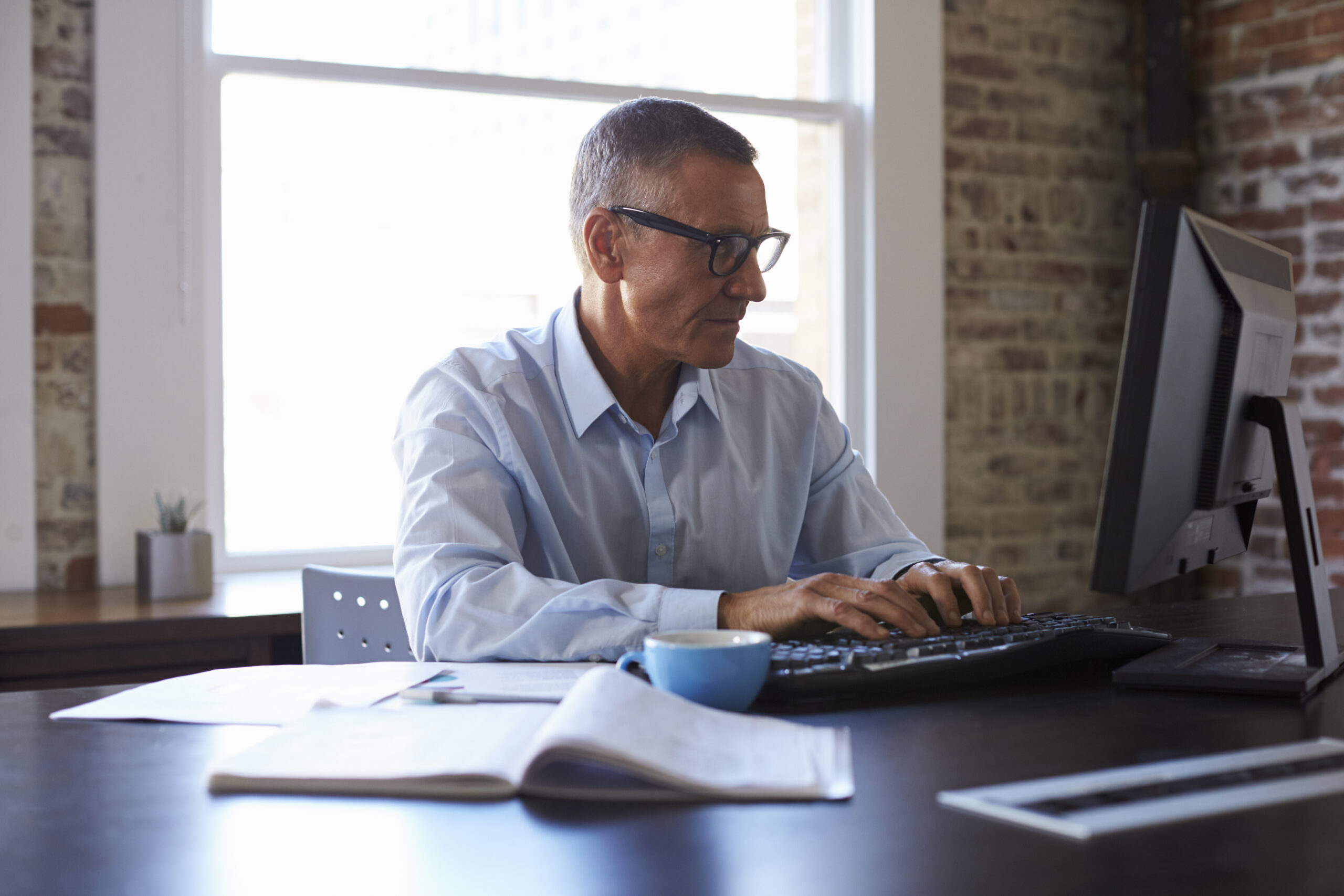 Self-employed professional managing his Self-Directed 401(k) investments from his office