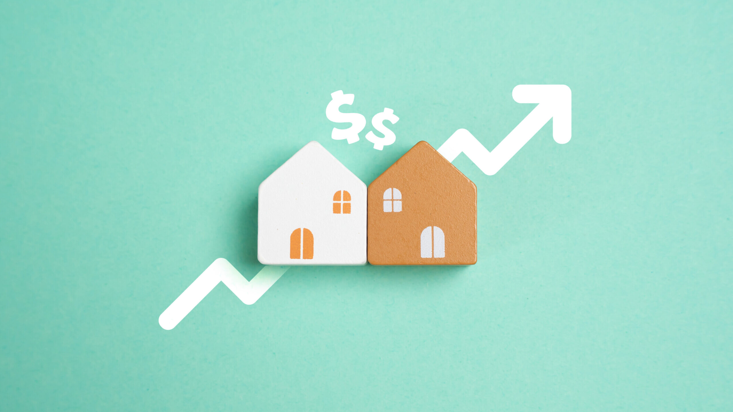 Two house models beside a rising arrow and dollar signs, symbolizing growing real estate investment value
