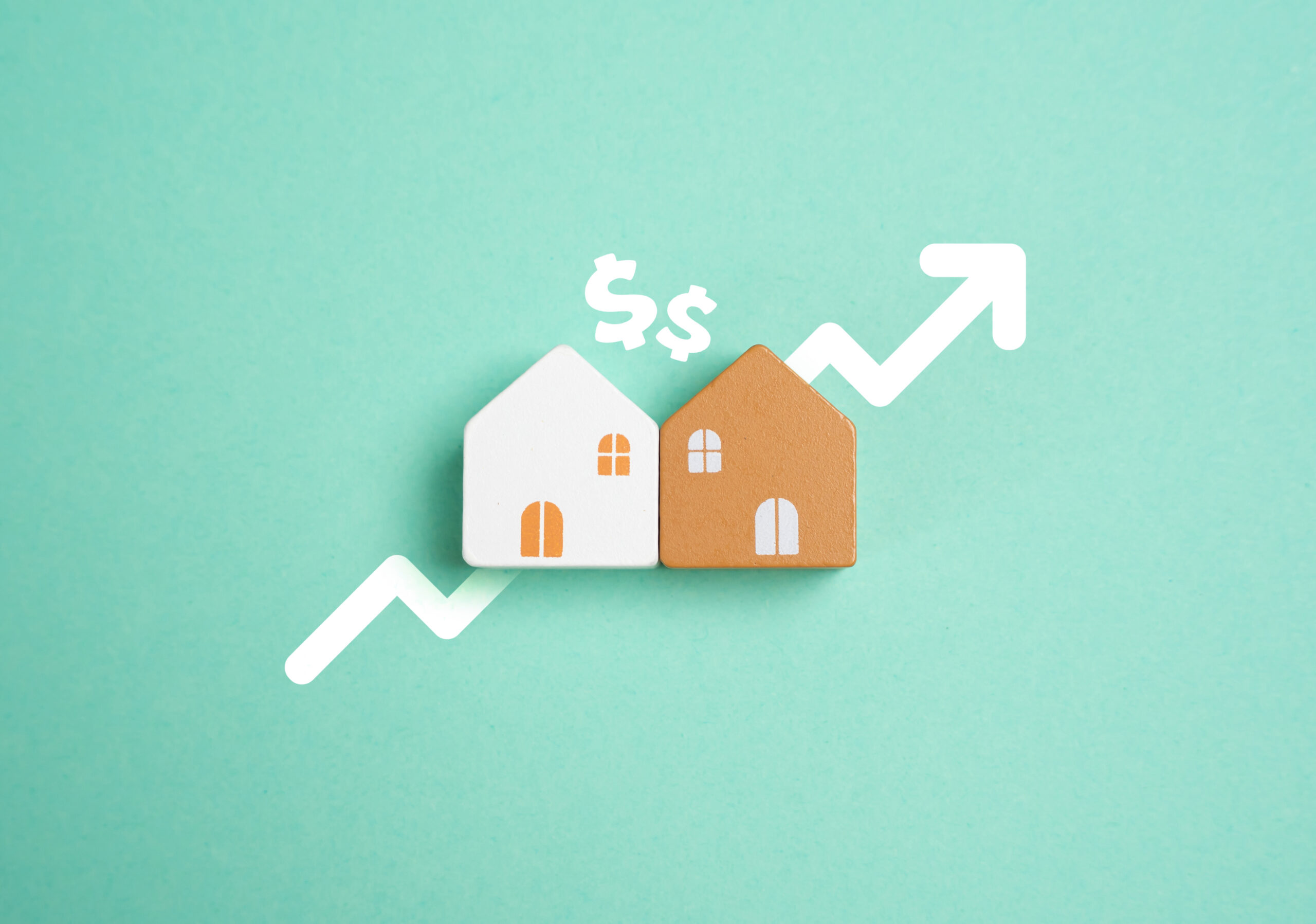 Two house models beside a rising arrow and dollar signs, symbolizing growing real estate investment value