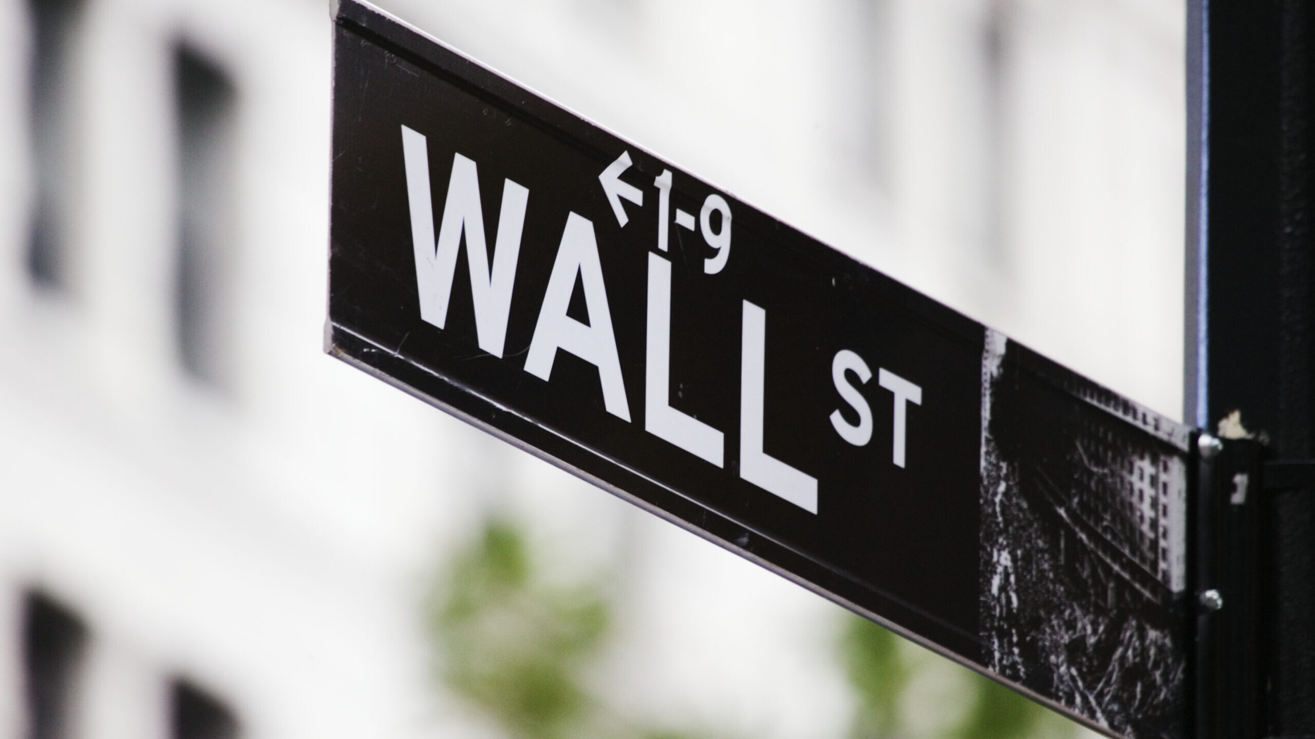 Wall Street sign against a Financial District building, representing regulatory capture in retirement investing